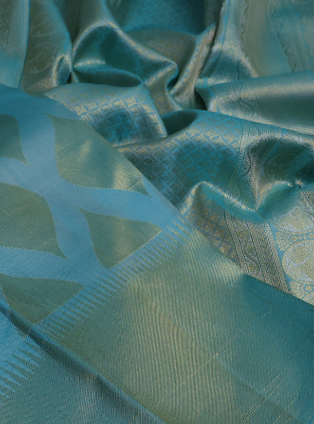 Pure kanchipuram silk saree teal blue with allover zari woven geometric butta weaves and temple design zari woven border