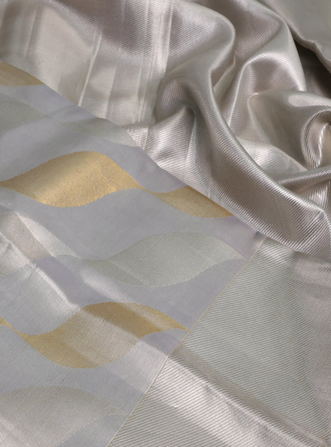 Pure kanchipuram tissue silk saree pastel grey with allover silver & gold zari woven brocade weaves and silver zari woven border