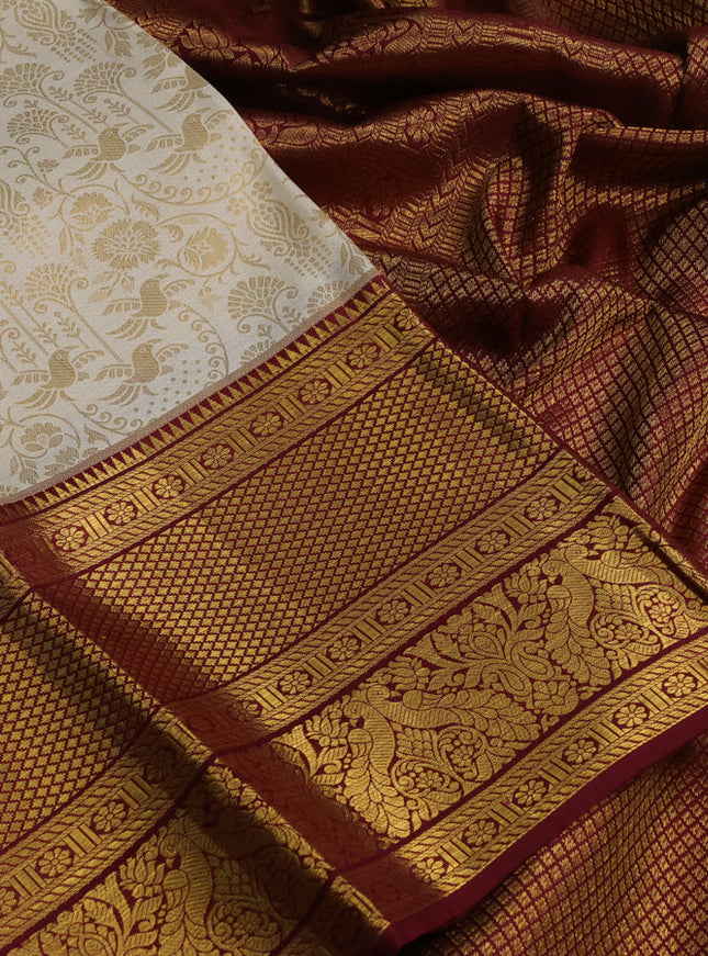 Pure kanchipuram silk saree off white and maroon with allover zari woven brocade weaves and zari woven border
