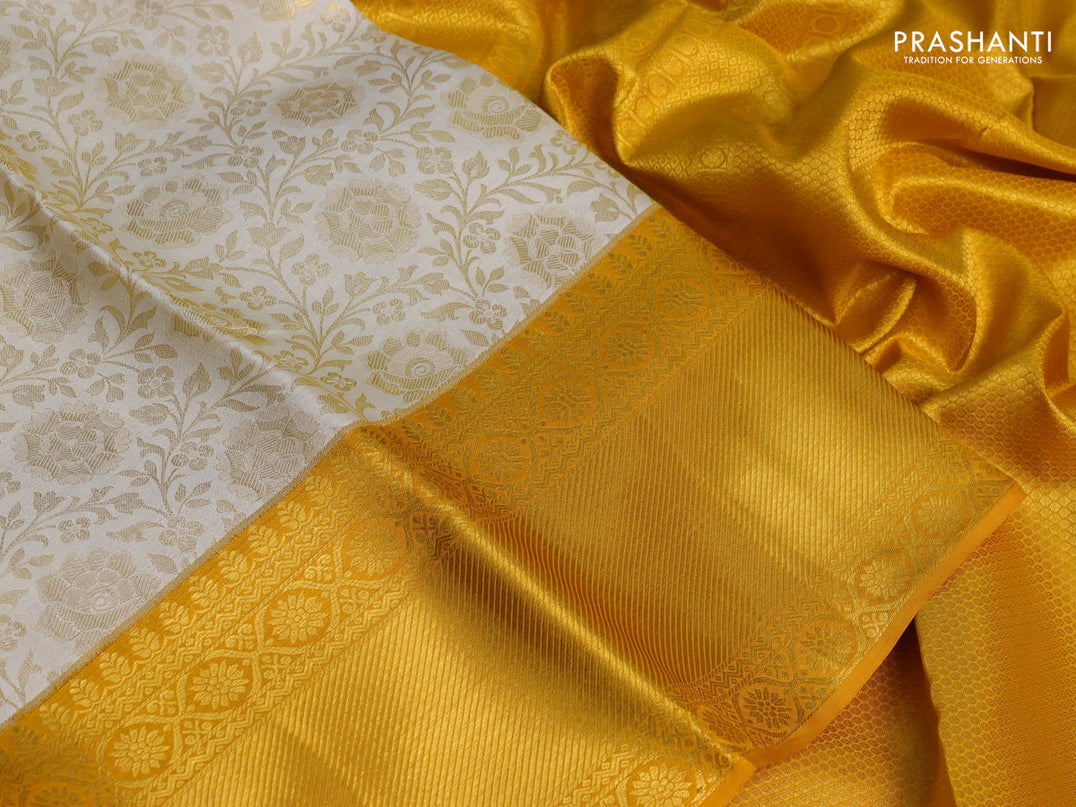 Pure kanchipuram silk saree off white and mustard yellow with allover zari woven brocade weaves and zari woven border