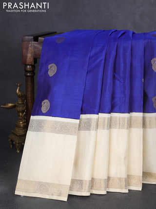 Pure kanchipuram silk saree blue and cream with paisley zari woven buttas and long rettapet zari woven korvai border