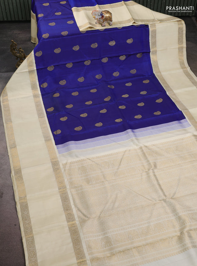 Pure kanchipuram silk saree blue and cream with paisley zari woven buttas and long rettapet zari woven korvai border