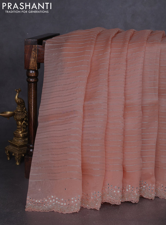 Pure organza silk saree peach orange with allover zari weaves and sequin mirror work border