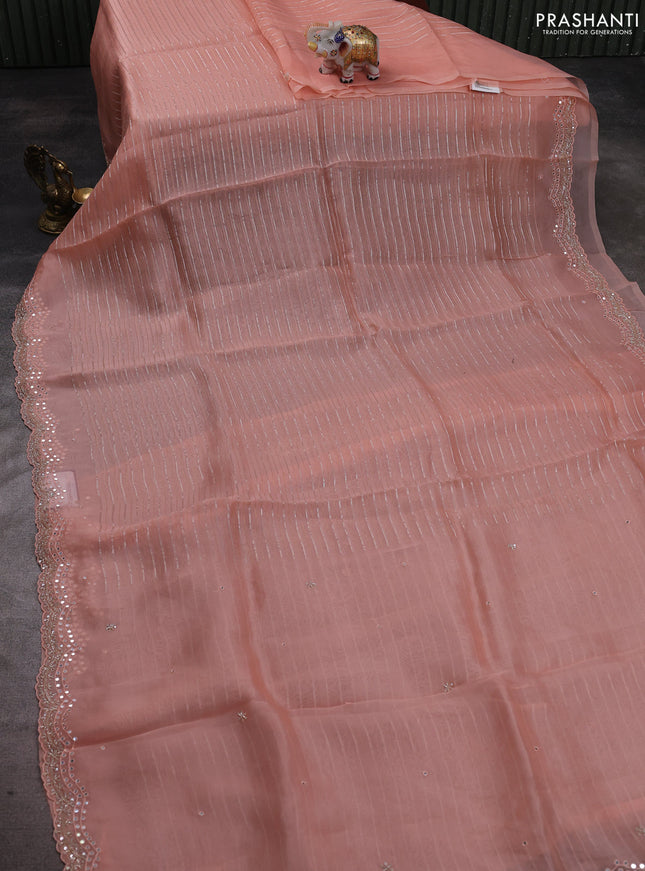 Pure organza silk saree peach orange with allover zari weaves and sequin mirror work border