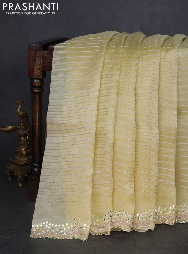 Pure organza silk saree pale yellow with allover zari weaves and sequin mirror work border
