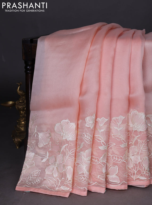 Pure organza silk saree pale orange with plain body and floral embroidery border