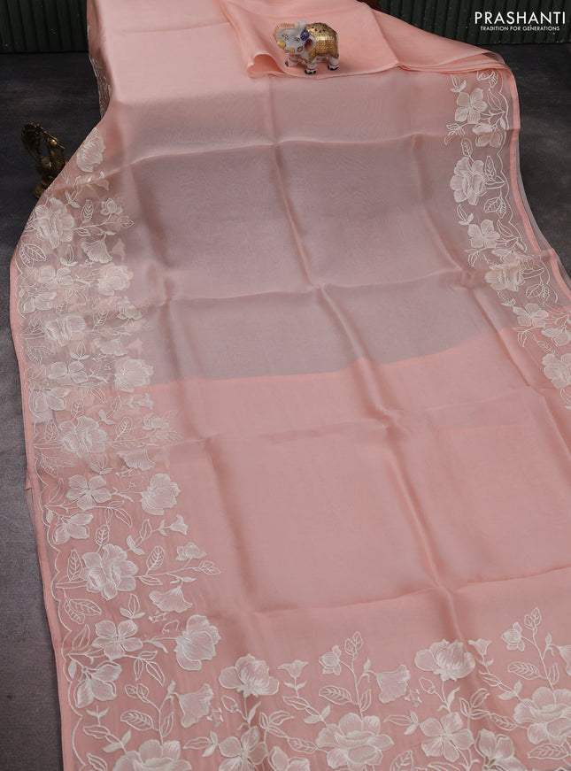 Pure organza silk saree pale orange with plain body and floral embroidery border