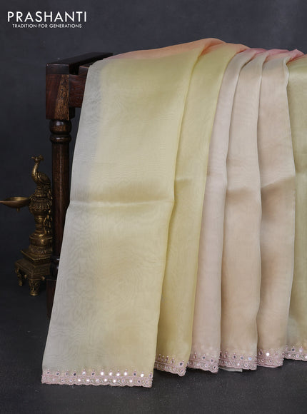 Pure organza silk saree pale yellow and peach with plain body and embroidery mirror work border