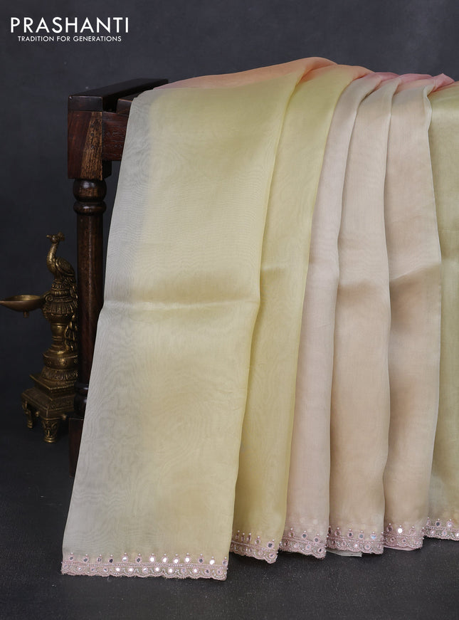 Pure organza silk saree pale yellow and peach with plain body and embroidery mirror work border