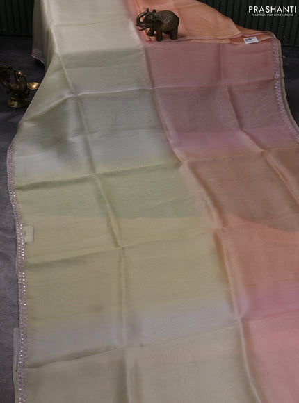 Pure organza silk saree pale yellow and peach with plain body and embroidery mirror work border