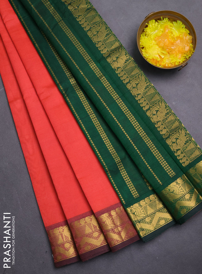 Silk cotton saree peach shade and bottle green with plain body and zari woven border