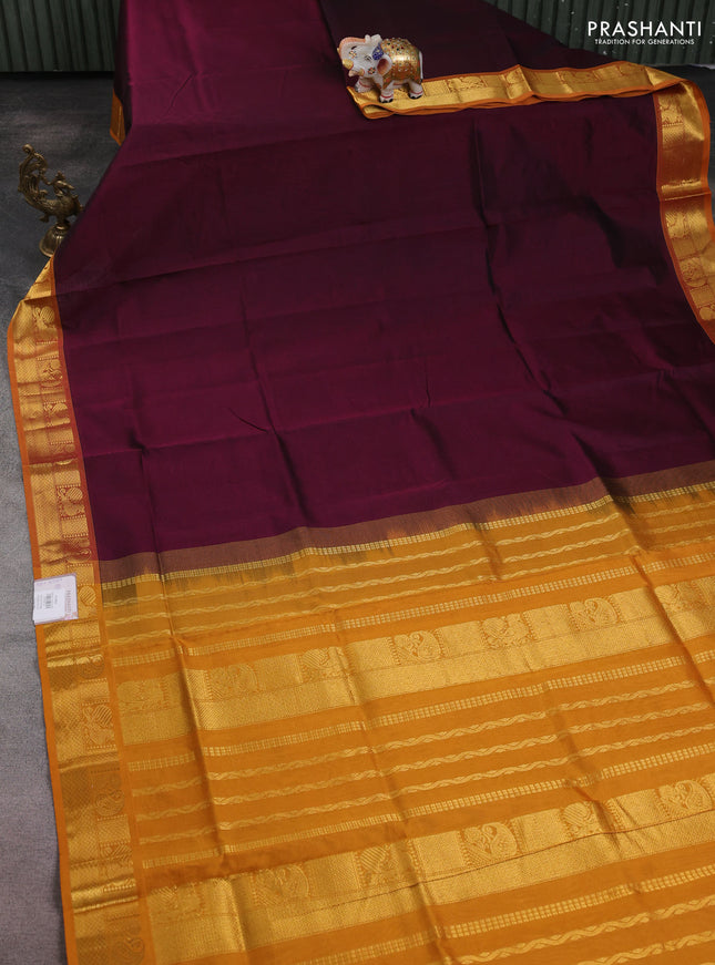 Silk cotton saree wine shade and mustard yellow with plain body and zari woven border