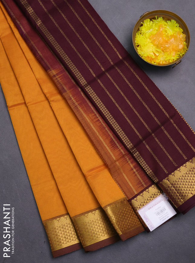Silk cotton saree mustard yellow and coffee brown with plain body and temple zari woven border
