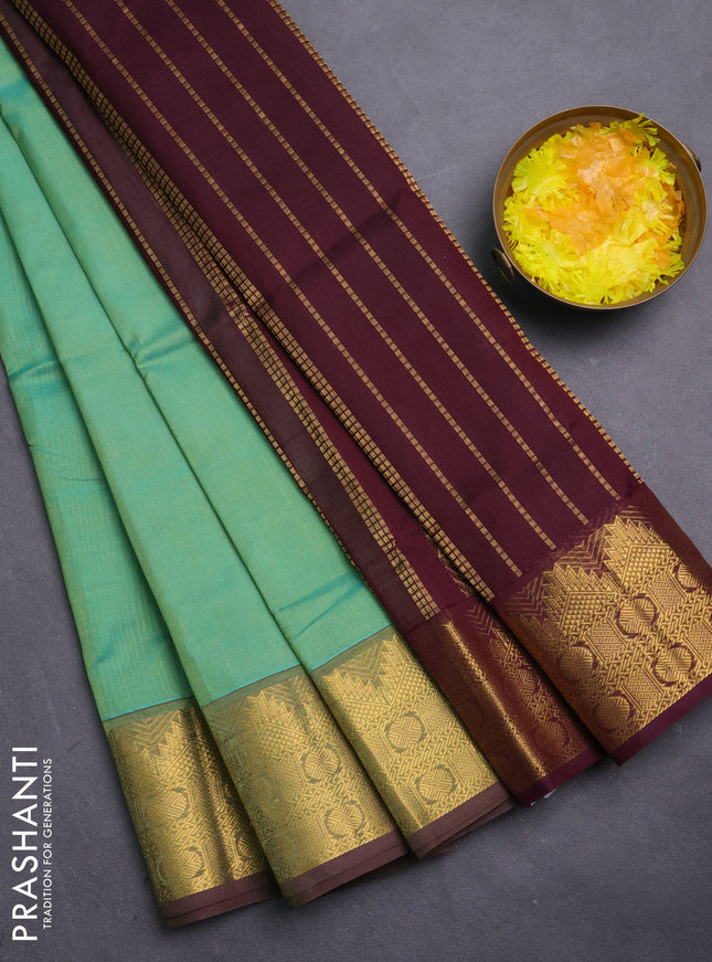 Silk cotton saree metallic green and deep maroon with plain body and zari woven border