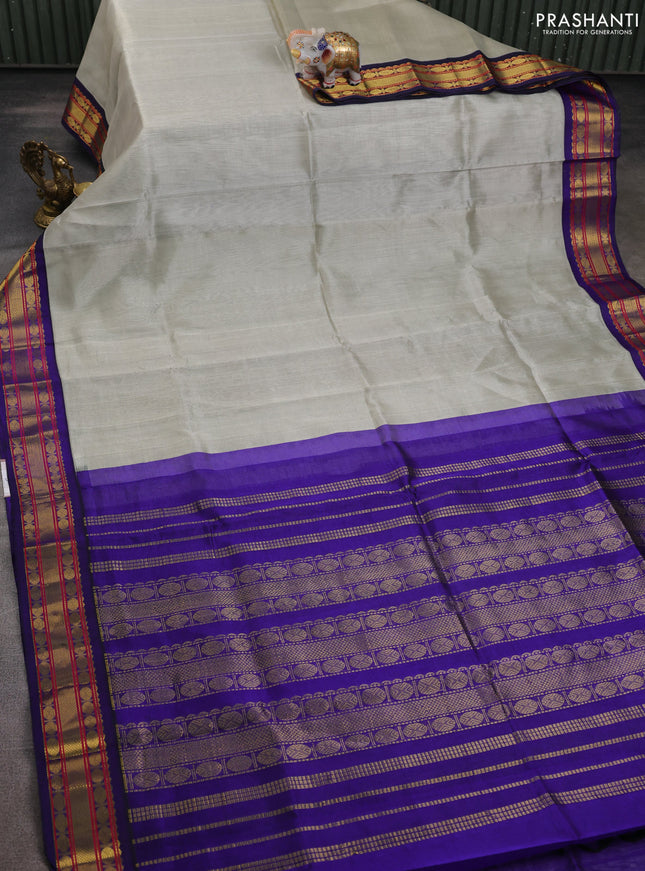 Silk cotton saree beige and blue with plain body and zari woven korvai border