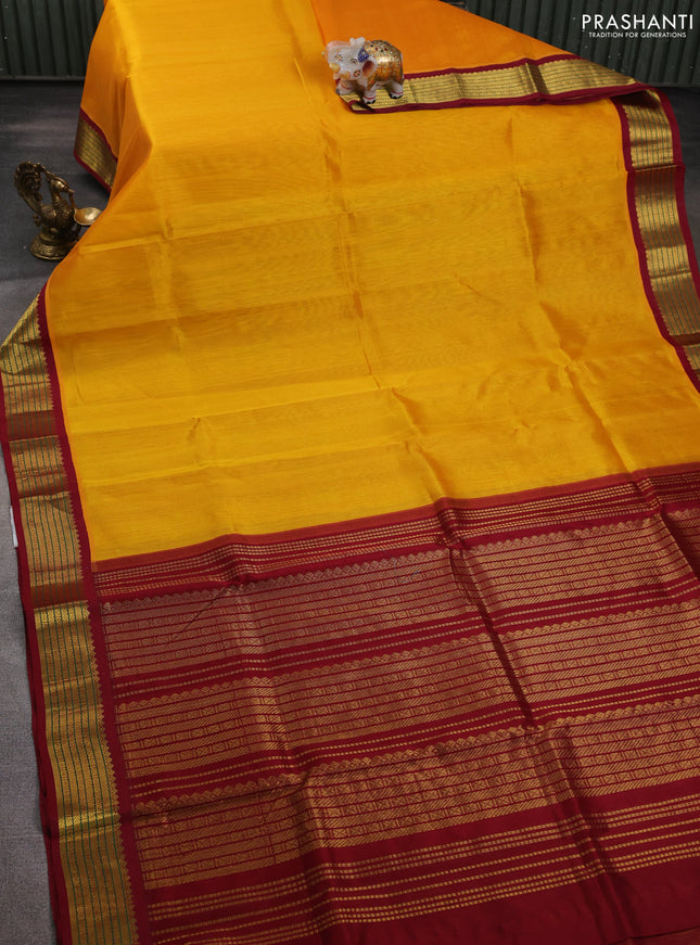 Silk cotton saree mango yellow and maroon with plain body and zari woven korvai border