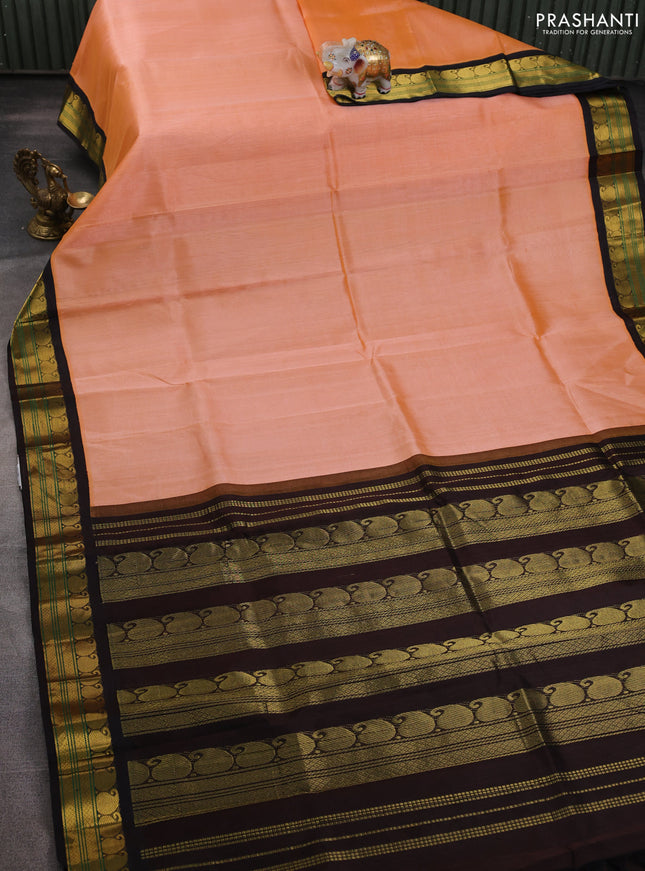 Silk cotton saree pale orange and coffee brown with plain body and paisley zari woven korvai border