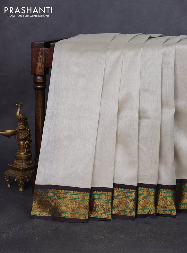 Silk cotton saree pastel grey and coffee brown with plain body and zari woven korvai border