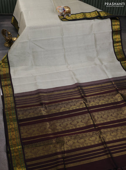 Silk cotton saree pastel grey and coffee brown with plain body and zari woven korvai border
