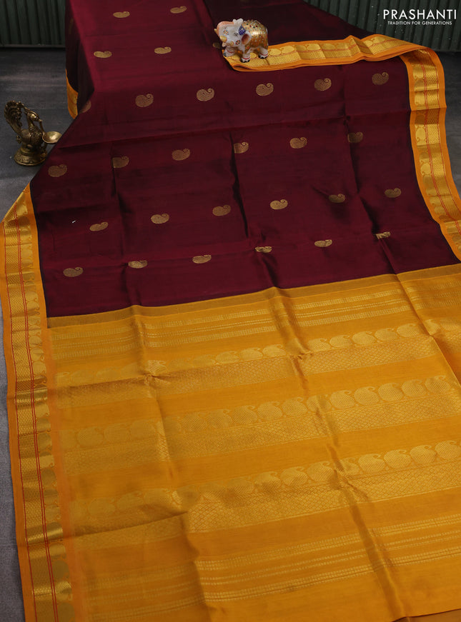 Silk cotton saree maroon and mustard yellow with paisley zari woven buttas and paisley zari woven korvai border