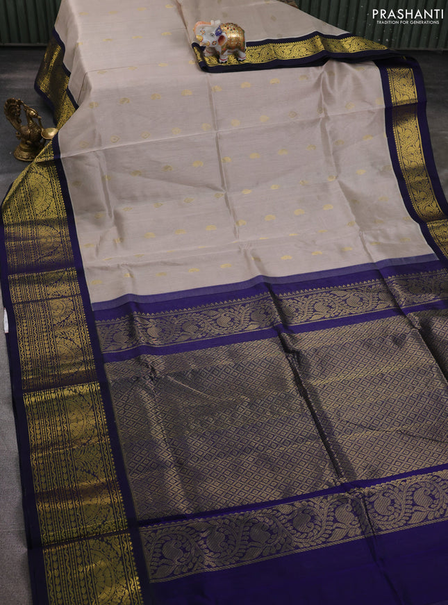 Silk cotton saree pastel grey and navy blue with paisley zari woven buttas and long zari woven korvai border