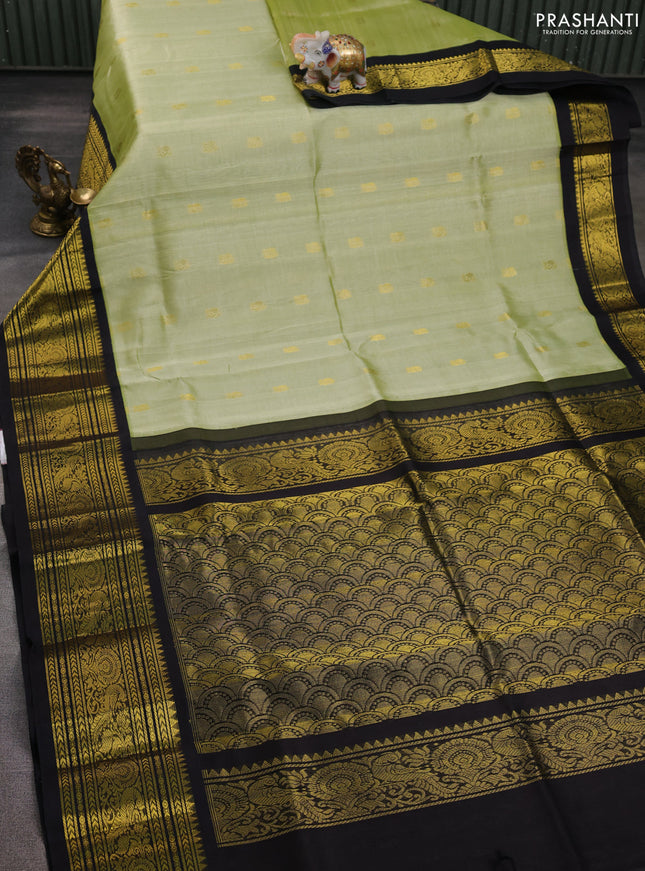 Silk cotton saree pista green and black with zari woven buttas and long zari woven korvai border