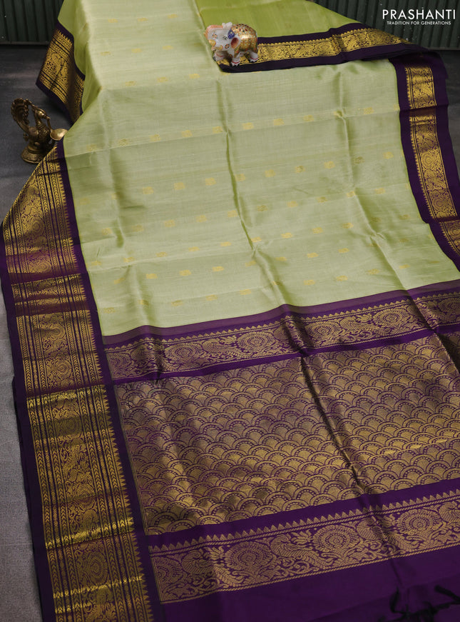 Silk cotton saree mild pita green and purple with zari woven buttas and long zari woven korvai border