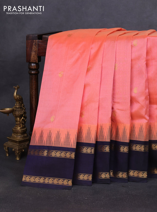 Silk cotton saree pale orange and navy blue with paisley zari woven buttas and temple design rettapet zari woven korvai border