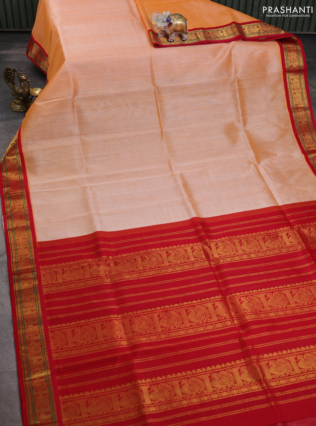 Silk cotton saree pale orange and red with plain body and annam zari woven korvai border