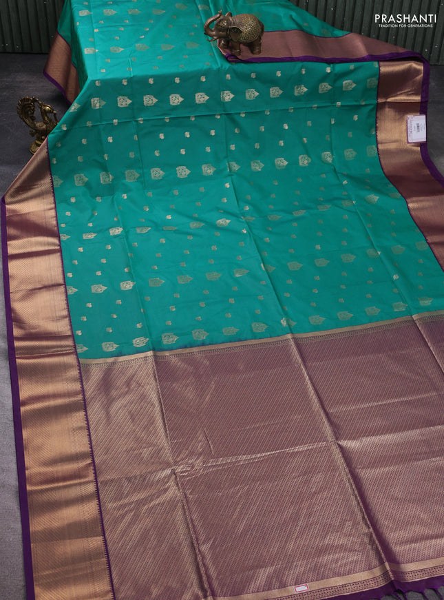 Semi soft silk saree teal green and purple with allover zari woven buttas and zari woven korvai border