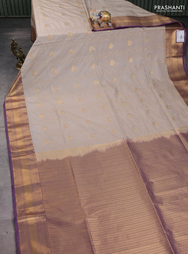 Semi soft silk saree beige and purple with allover zari woven buttas and zari woven korvai border