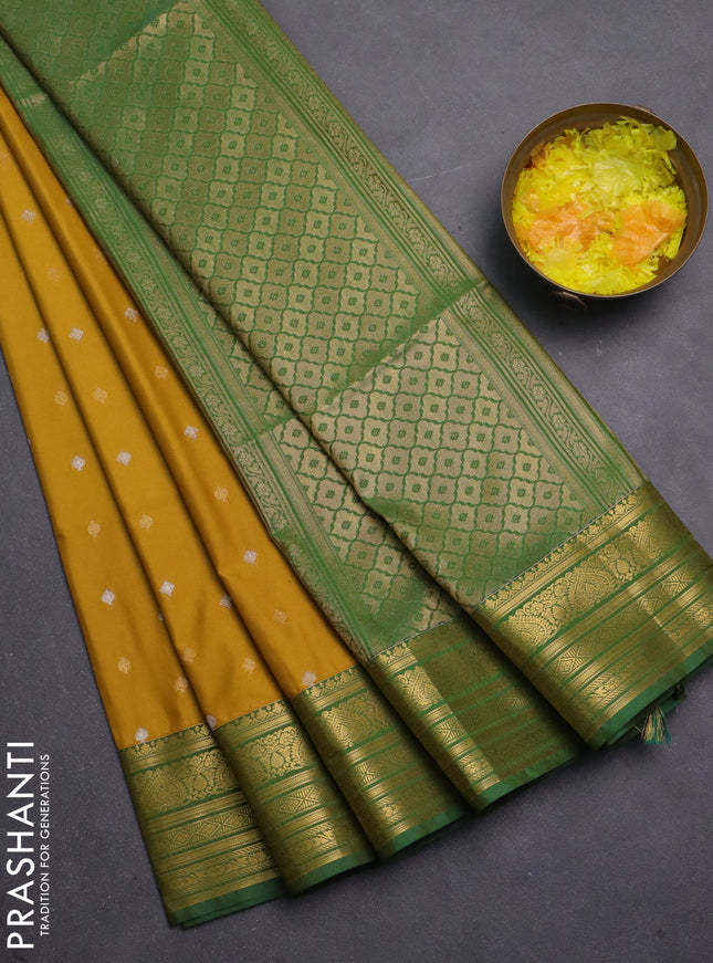 Semi soft silk saree mustard yellow and green with allover zari woven buttas and zari woven korvai border
