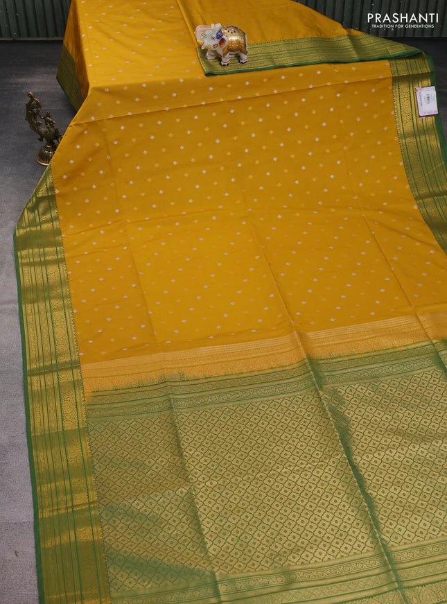 Semi soft silk saree mustard yellow and green with allover zari woven buttas and zari woven korvai border