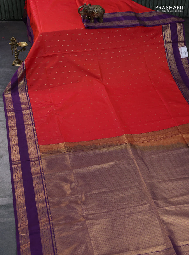 Semi soft silk saree rustic orange and purple with allover zari woven buttas and rettapet zari woven border