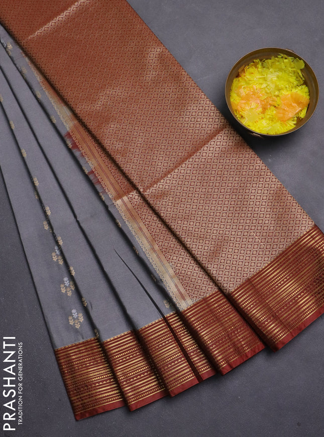 Semi soft silk saree grey and rust shade with allover zari woven buttas and zari woven korvai border
