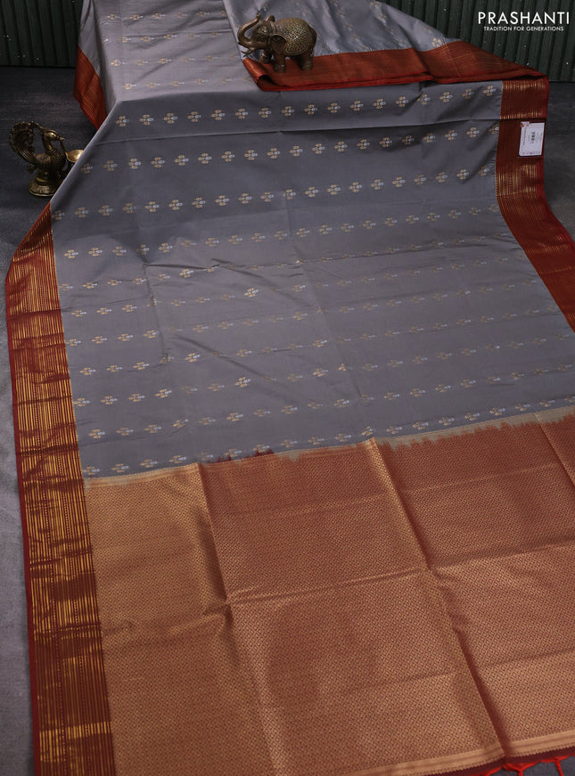 Semi soft silk saree grey and rust shade with allover zari woven buttas and zari woven korvai border