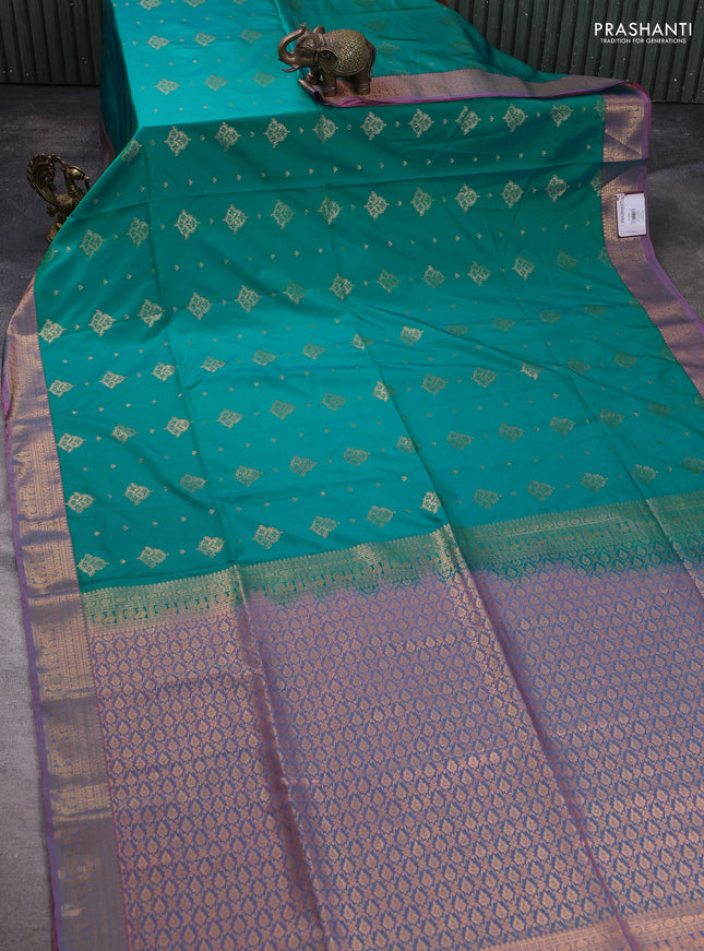 Semi soft silk saree teal green and peach shade with allover zari woven buttas and zari woven korvai border