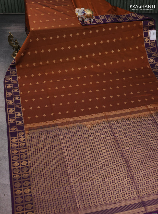 Semi soft silk saree rust shade and purple with allover zari woven buttas and rettapet zari woven border