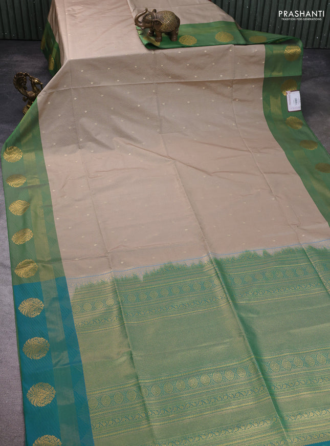 Semi soft silk saree beige and green with allover zari weaves & buttas and zari woven border