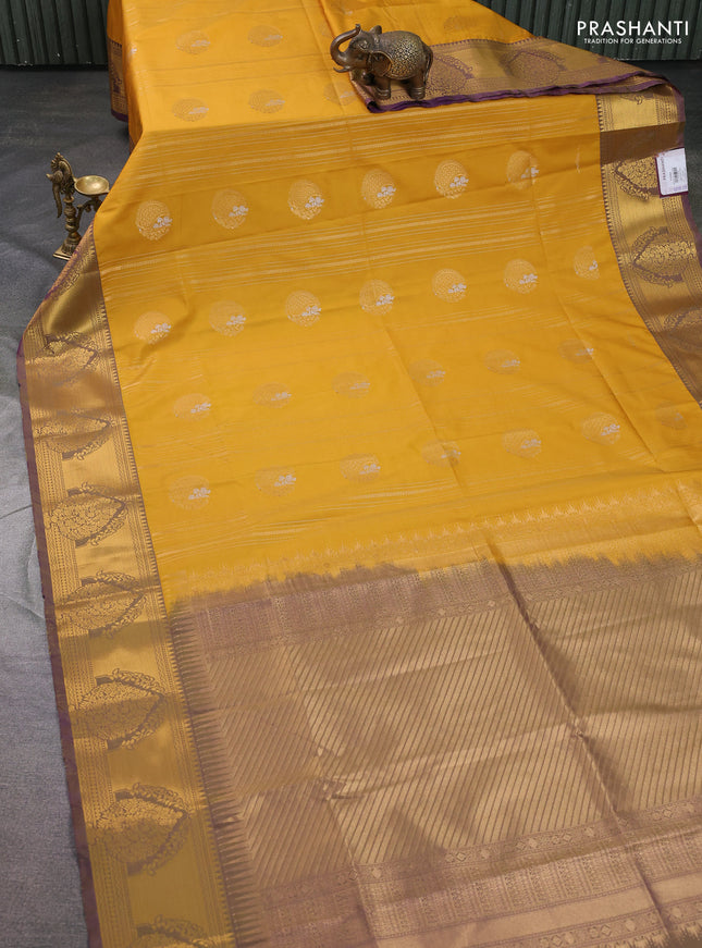 Semi soft silk saree mustard yellow and violet with allover zari weaves & buttas and zari woven butta korvai border
