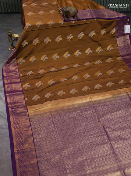 Semi soft silk saree dark mustard and purple witrh zari woven buttas and zari woven border