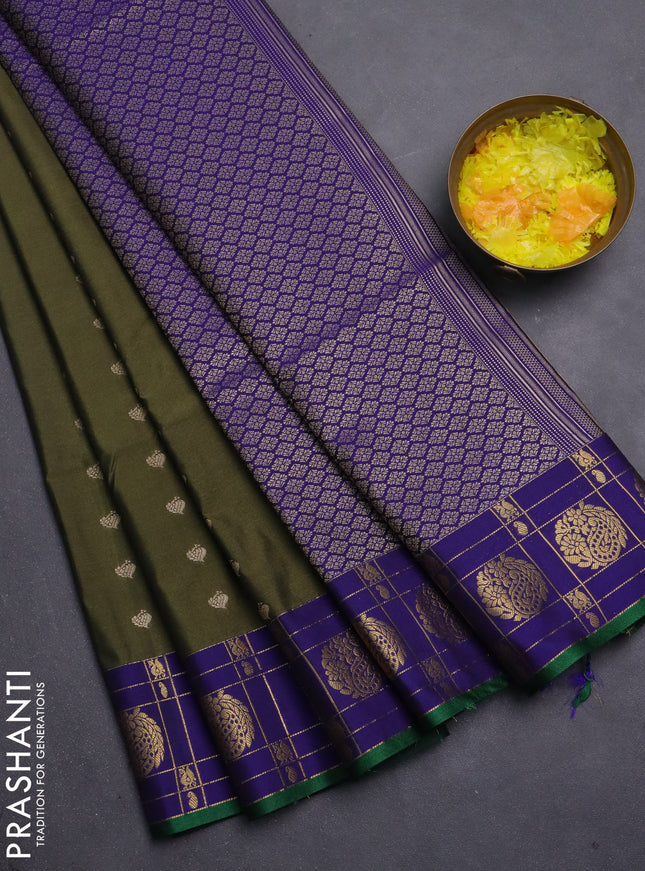 Semi soft silk saree dark sap green and blue with allover zari woven buttas and zari woven korvai border