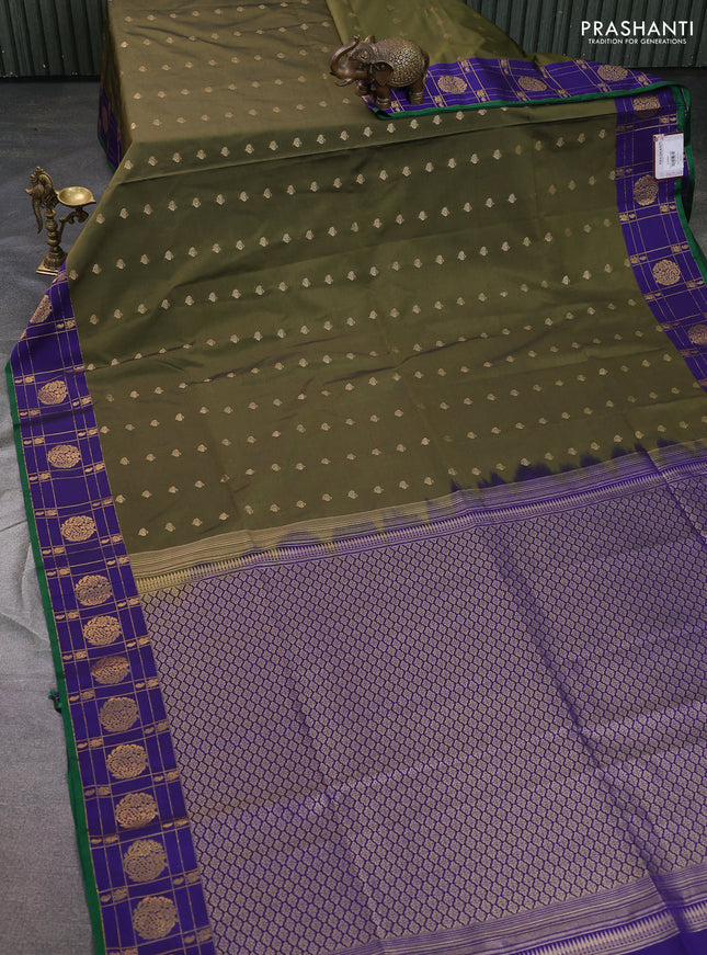 Semi soft silk saree dark sap green and blue with allover zari woven buttas and zari woven korvai border
