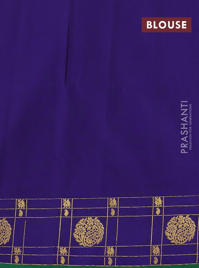 Semi soft silk saree dark sap green and blue with allover zari woven buttas and zari woven korvai border