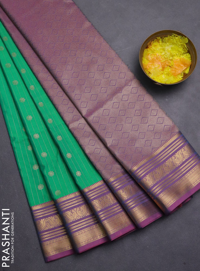 Semi soft silk saree teal green and peach pink with allover zari weaves & buttas and zari woven korvai border
