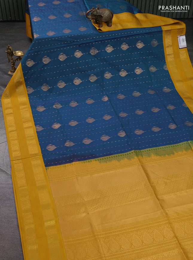 Semi soft silk saree blue and mustard yellow with allover zari woven buttas and zari woven korvai border