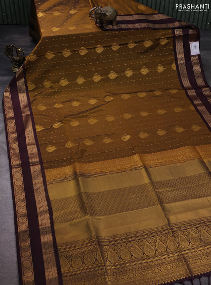 Semi soft silk saree dark mustard and coffee brown with allover zari woven buttas and zari woven korvai border