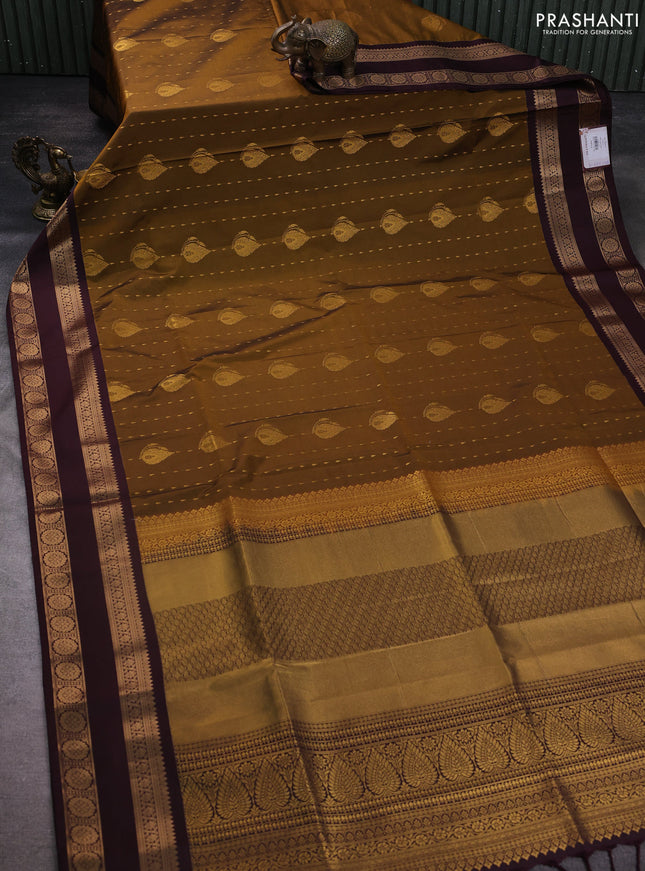 Semi soft silk saree dark mustard and coffee brown with allover zari woven buttas and zari woven korvai border