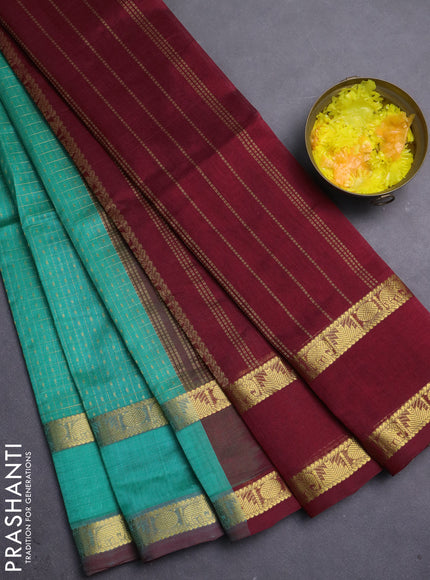 Silk cotton saree teal green and maroon with allover zari lakshadeepam patten and rettapet zari woven border