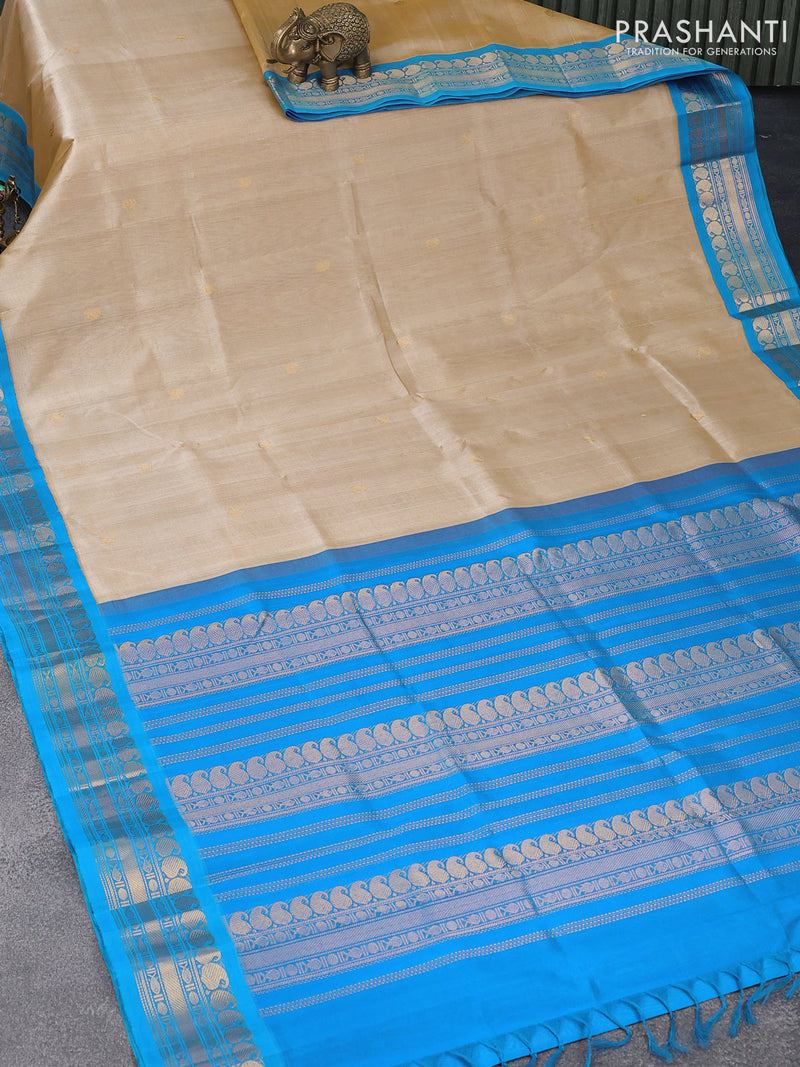 Silk cotton saree beige and cs blue with paisley zari woven buttas and paisley zari woven korvai border